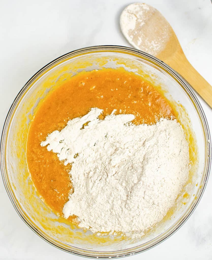 wet and dry ingredients being mixed together in a bowl