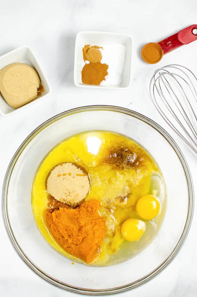 bananas, pumpkin, eggs, spices mixed together in a bowl