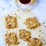 homemade healthy flapjacks, cut into squares and pictured on a sheet of parchment paper