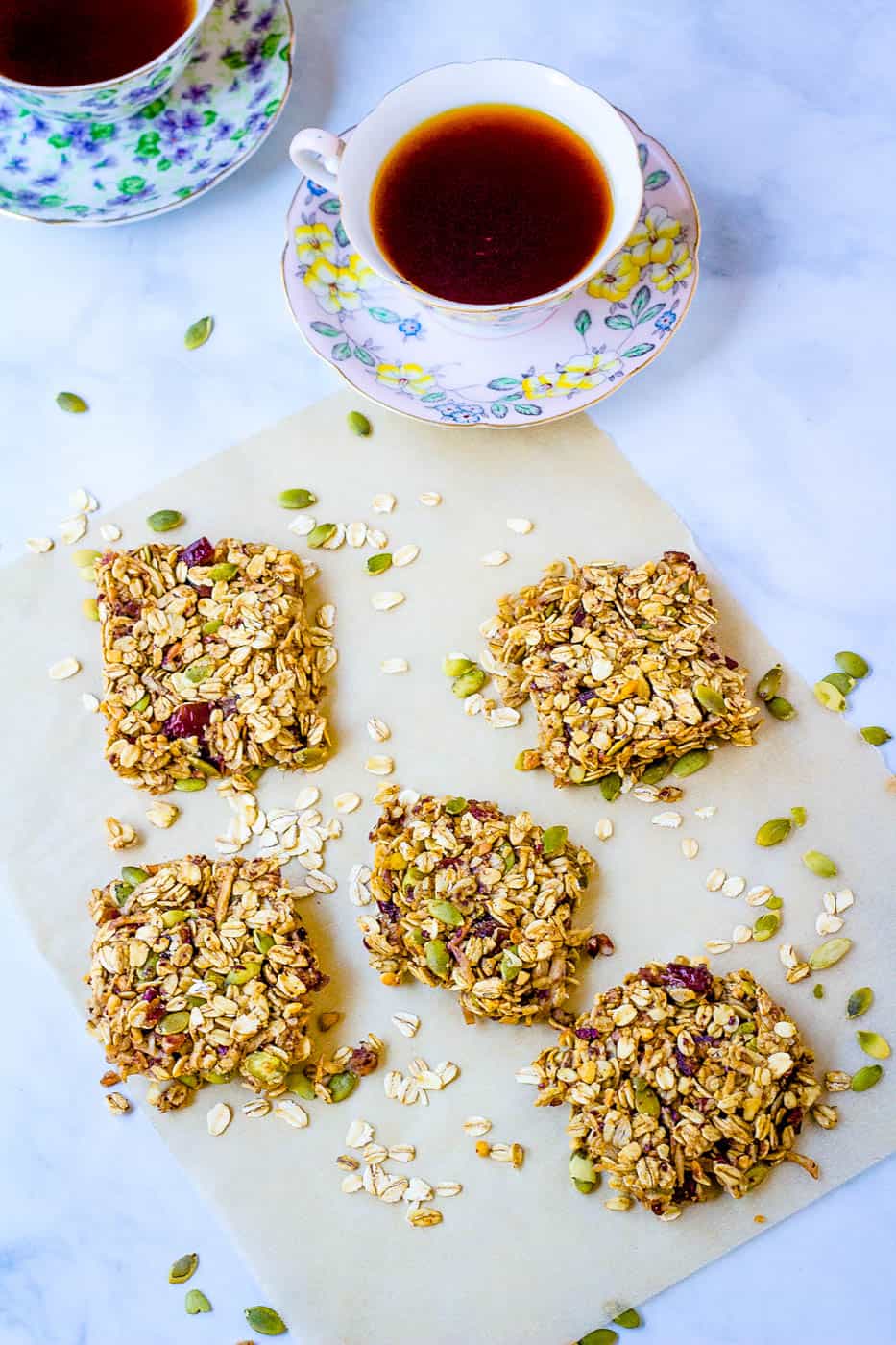 homemade healthy flapjacks, cut into squares and pictured on a sheet of parchment paper