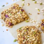 homemade healthy flapjacks, cut into squares and pictured on a sheet of parchment paper