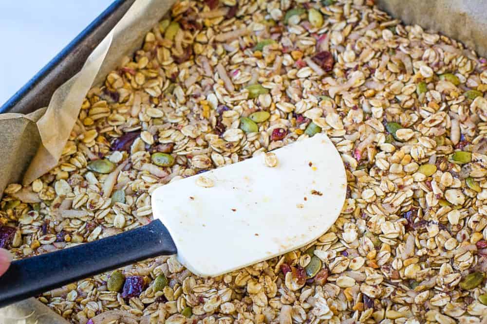 healthy flapjacks being pressed into a baking dish