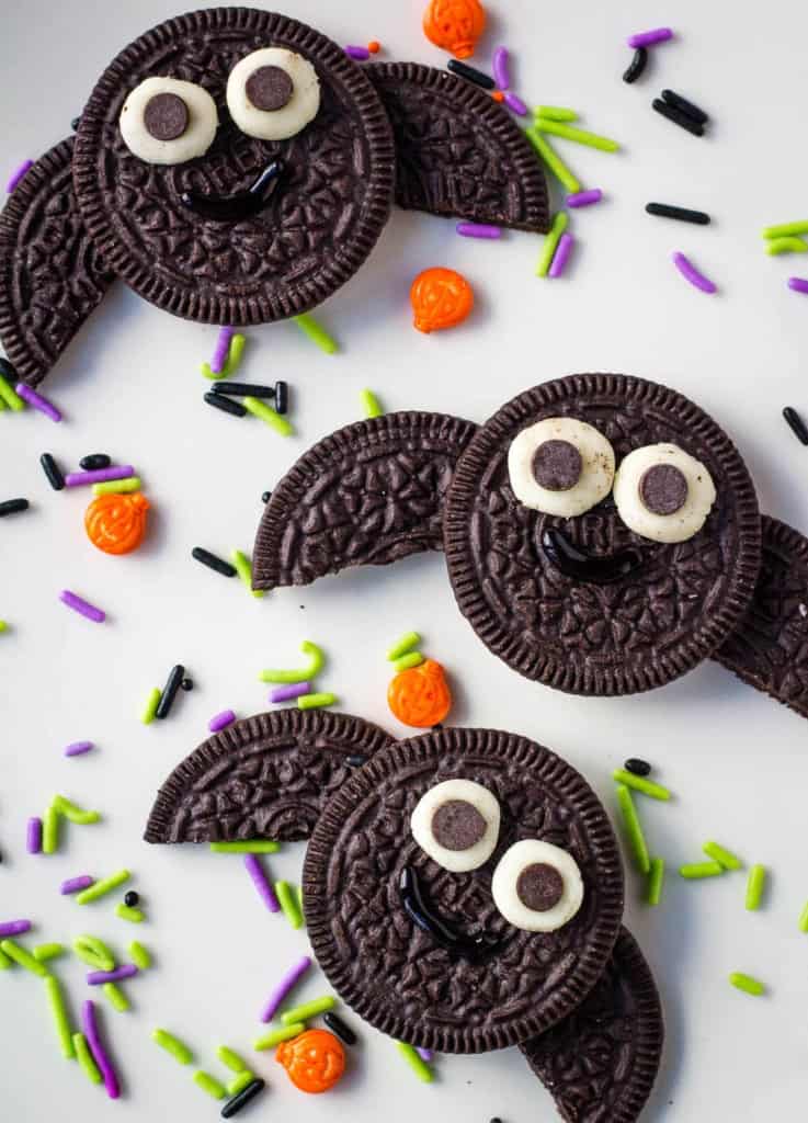 three oreo bats on white plate with sprinkles