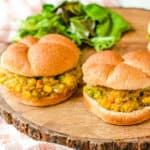 Pav Bhaji (or Indian Spiced Vegetarian Sloppy Joes) served on a wooden cutting board with a wheat bun