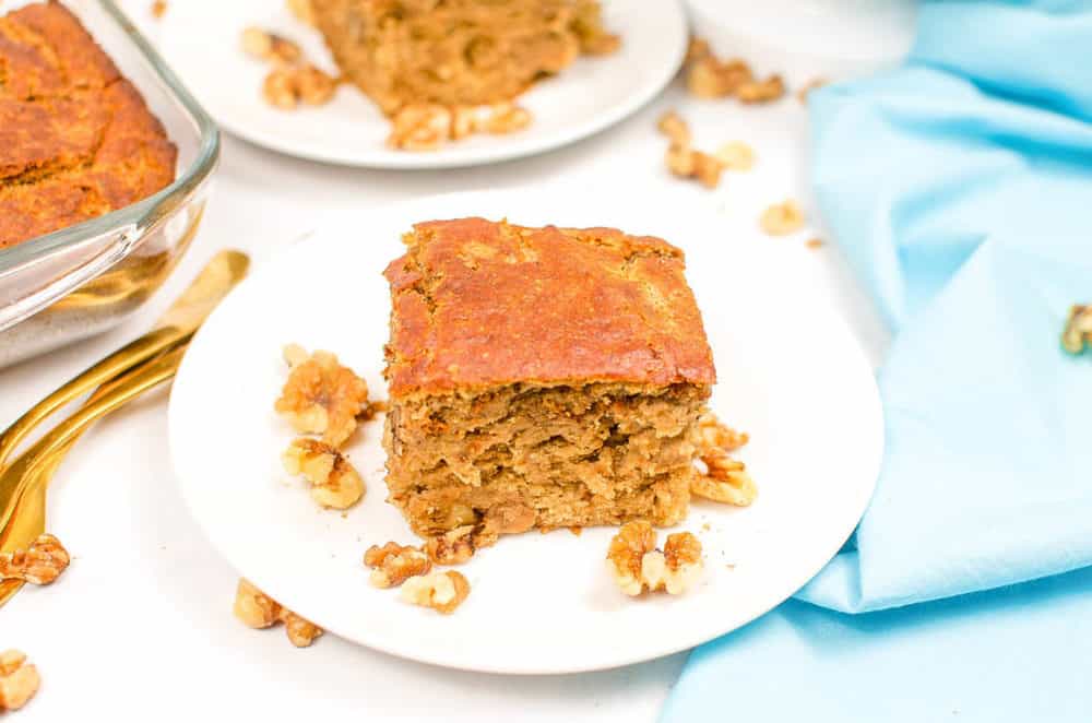 vegan banana bread, served on a white plate with a blue napkin in the background