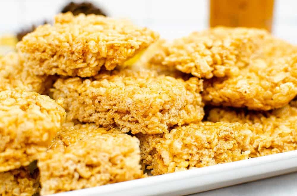 vegan rice krispie treats with pumpkin spice on a white platter