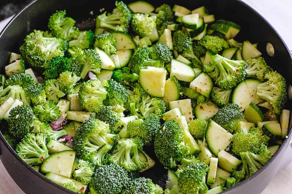 broccoli and zucchini sauteeing in a pan