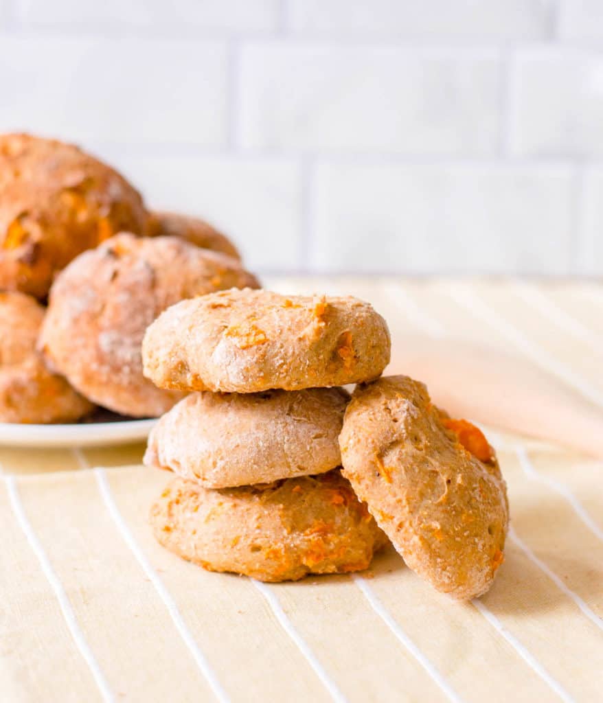 low calorie healthy biscuits made with sweet potato, stacked against a yellow and white background
