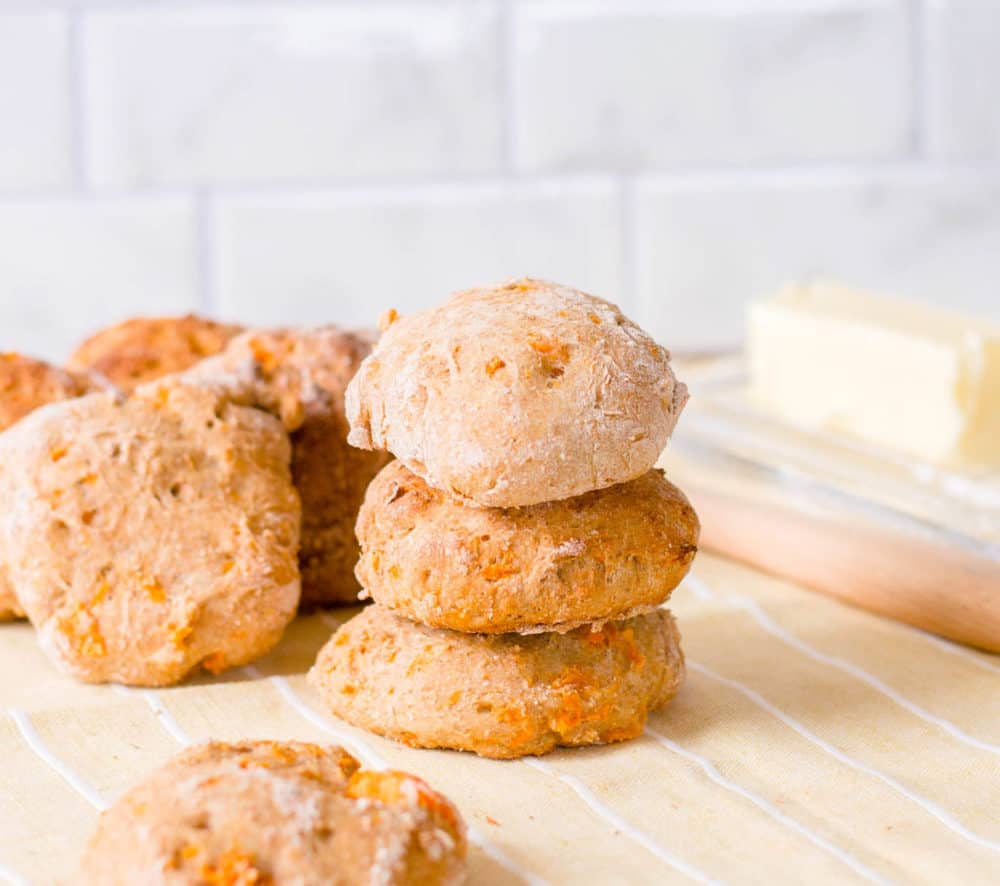 low calorie healthy biscuits made with sweet potato, stacked against a yellow and white background