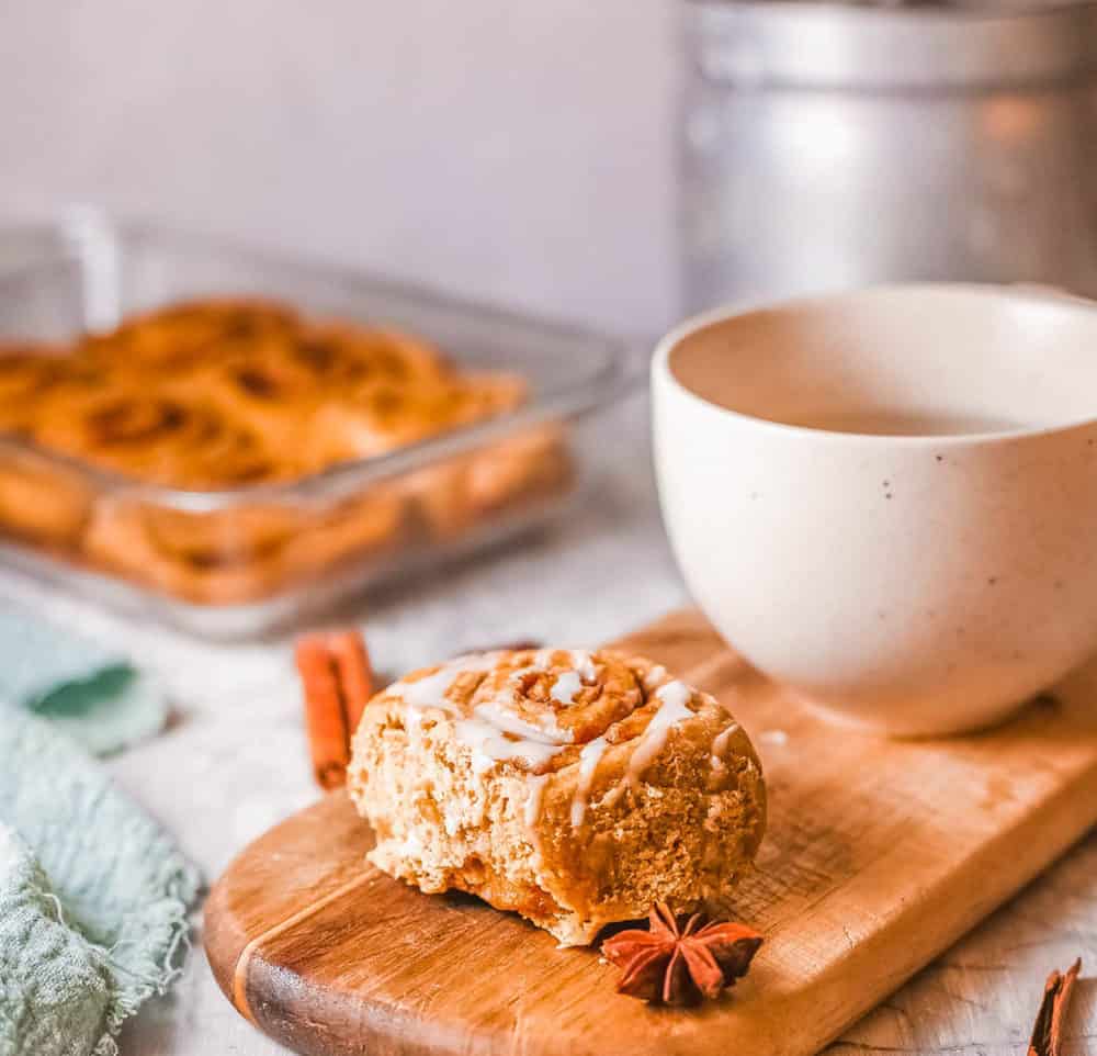 healthy cinnamon rolls, served on a wooden platter with a cup of tea