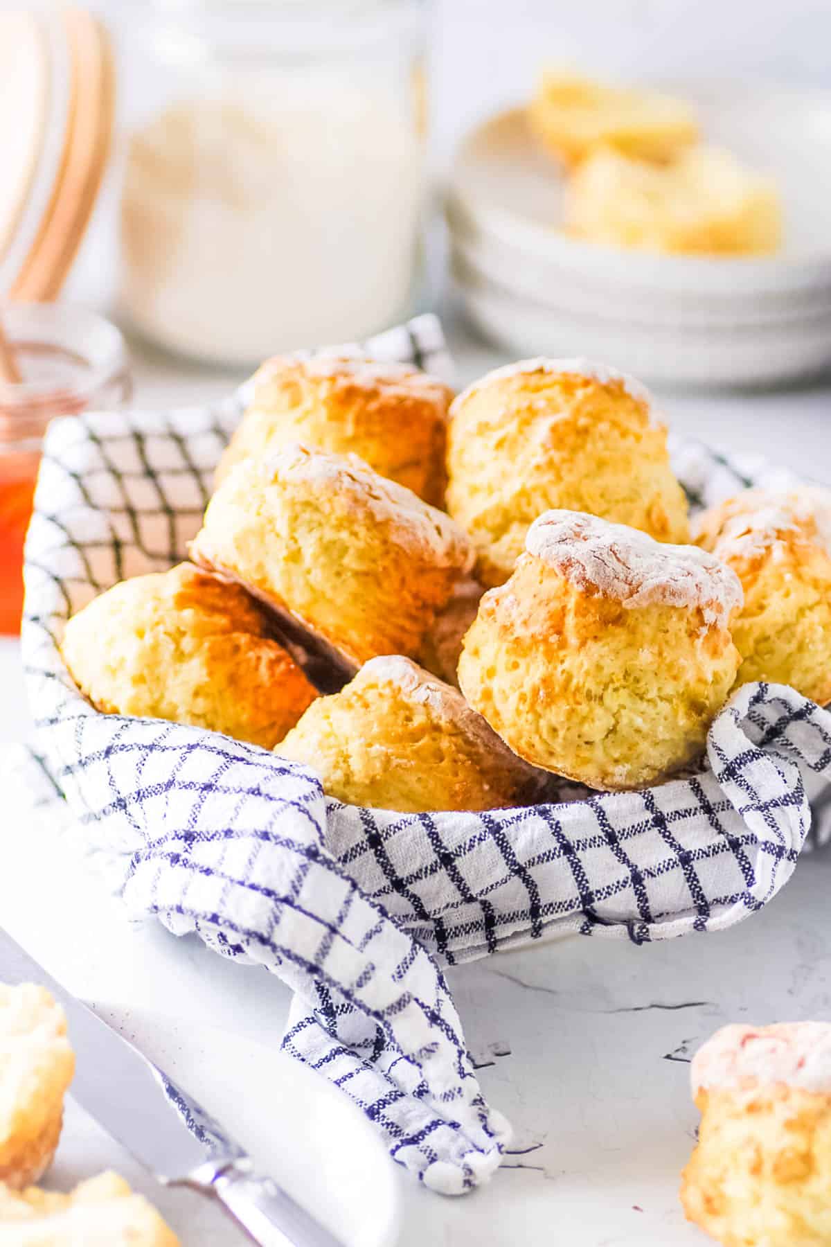 Healthy low calorie biscuits stacked in a large bowl lined with a kitchen cloth.