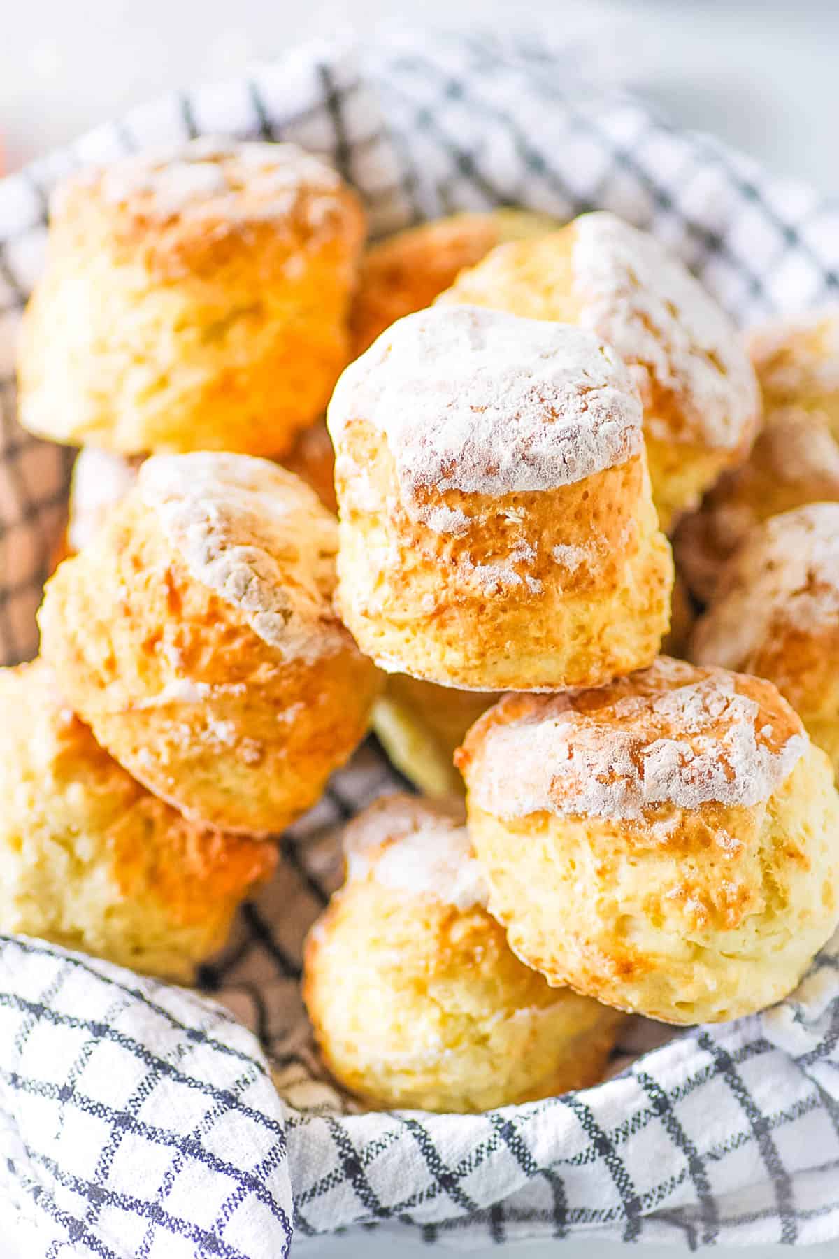 Healthy low calorie biscuits stacked in a large bowl lined with a kitchen cloth.