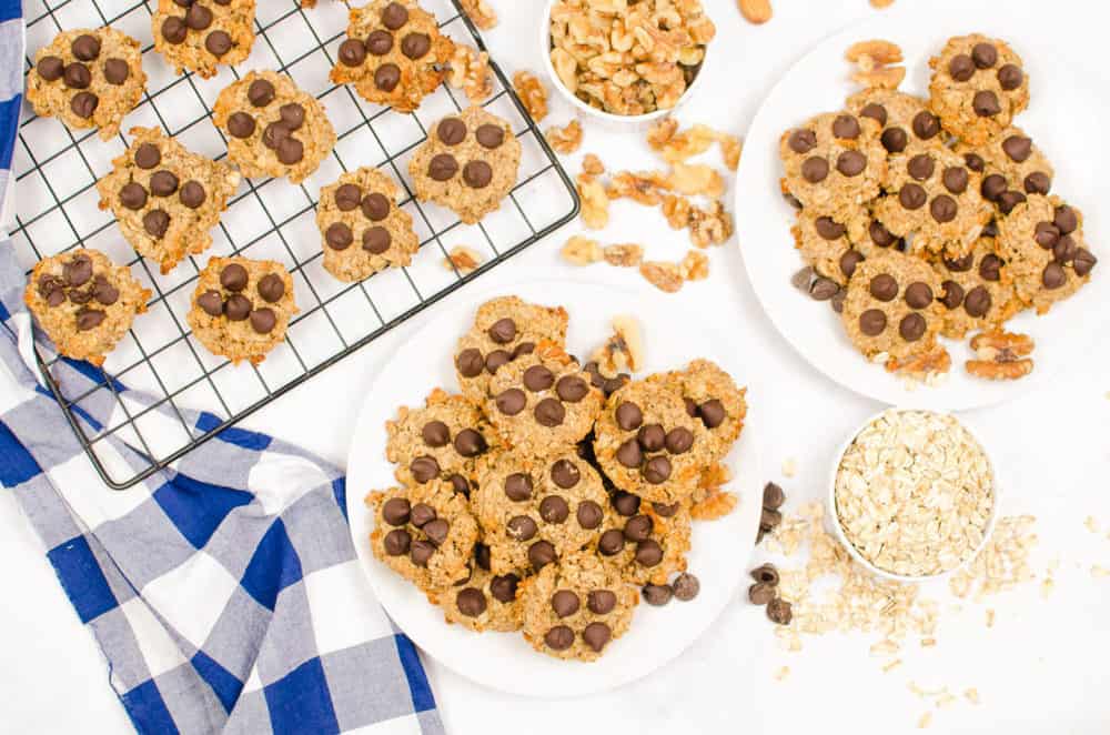 vegan peanut butter banana oatmeal cookies served on a white plate, topped with chocolate chips