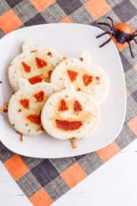 halloween jack-o-lantern pumpkin quesadillas served on a white plate
