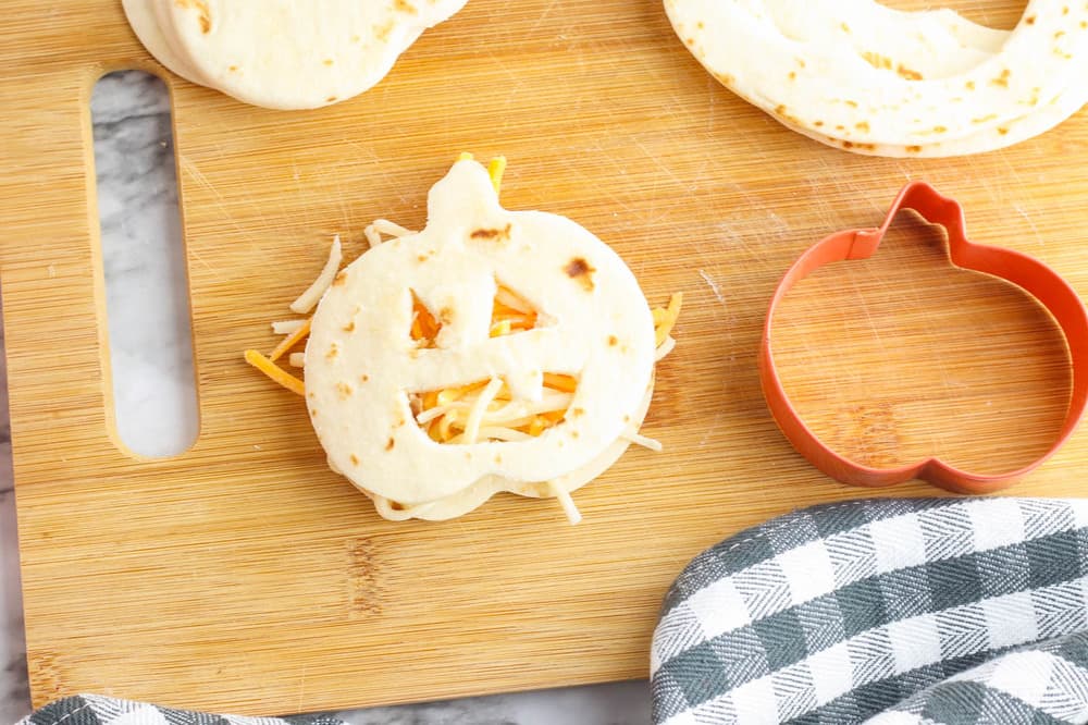 jack o lantern tortilla topping the quesadilla