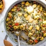 veggie gnocchi with spinach and white beans served in a large s،et