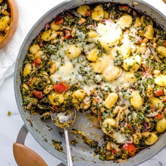 veggie gnocchi with spinach and white beans served in a large skillet