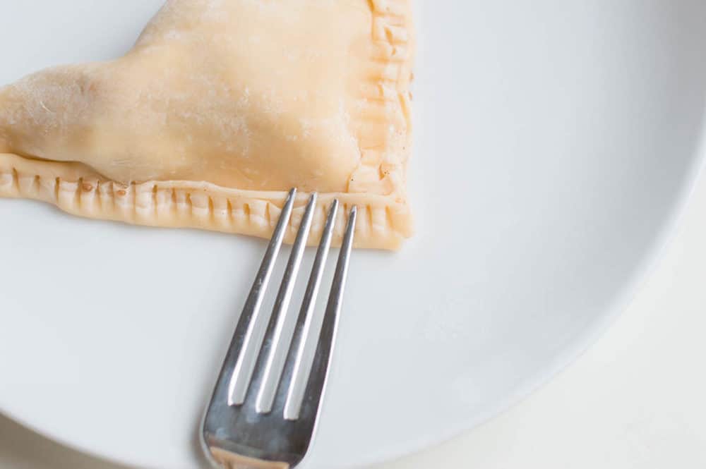 fork making indents in the pastry shell