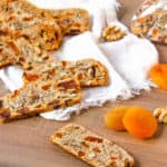 gluten free biscotti with apricots and walnuts on a wooden cutting board