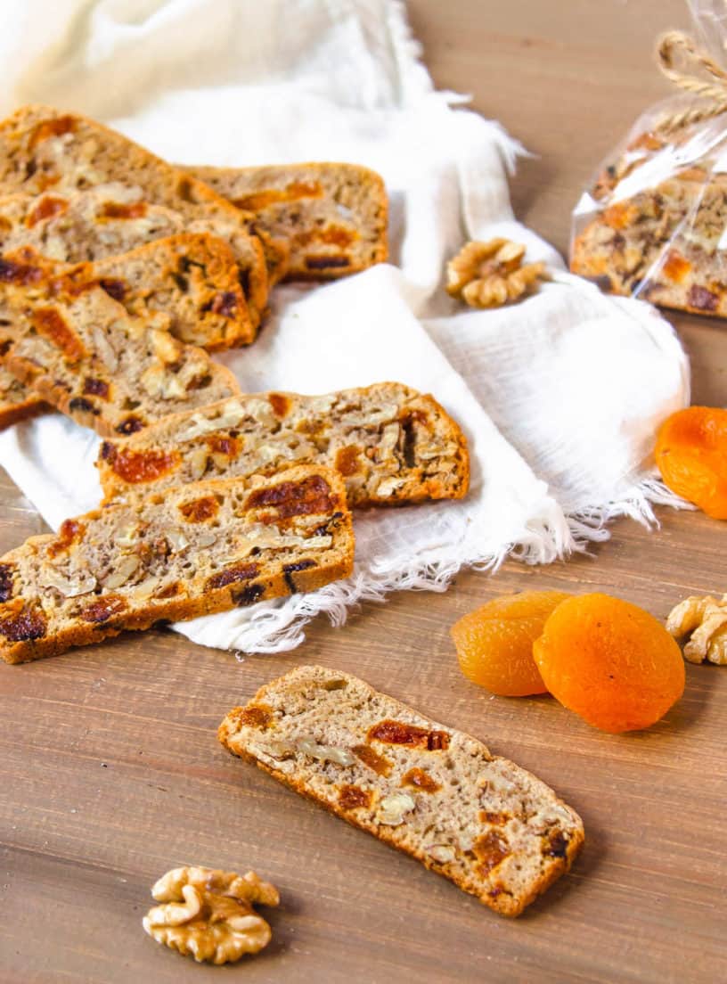 gluten free biscotti with apricots and walnuts on a wooden cutting board