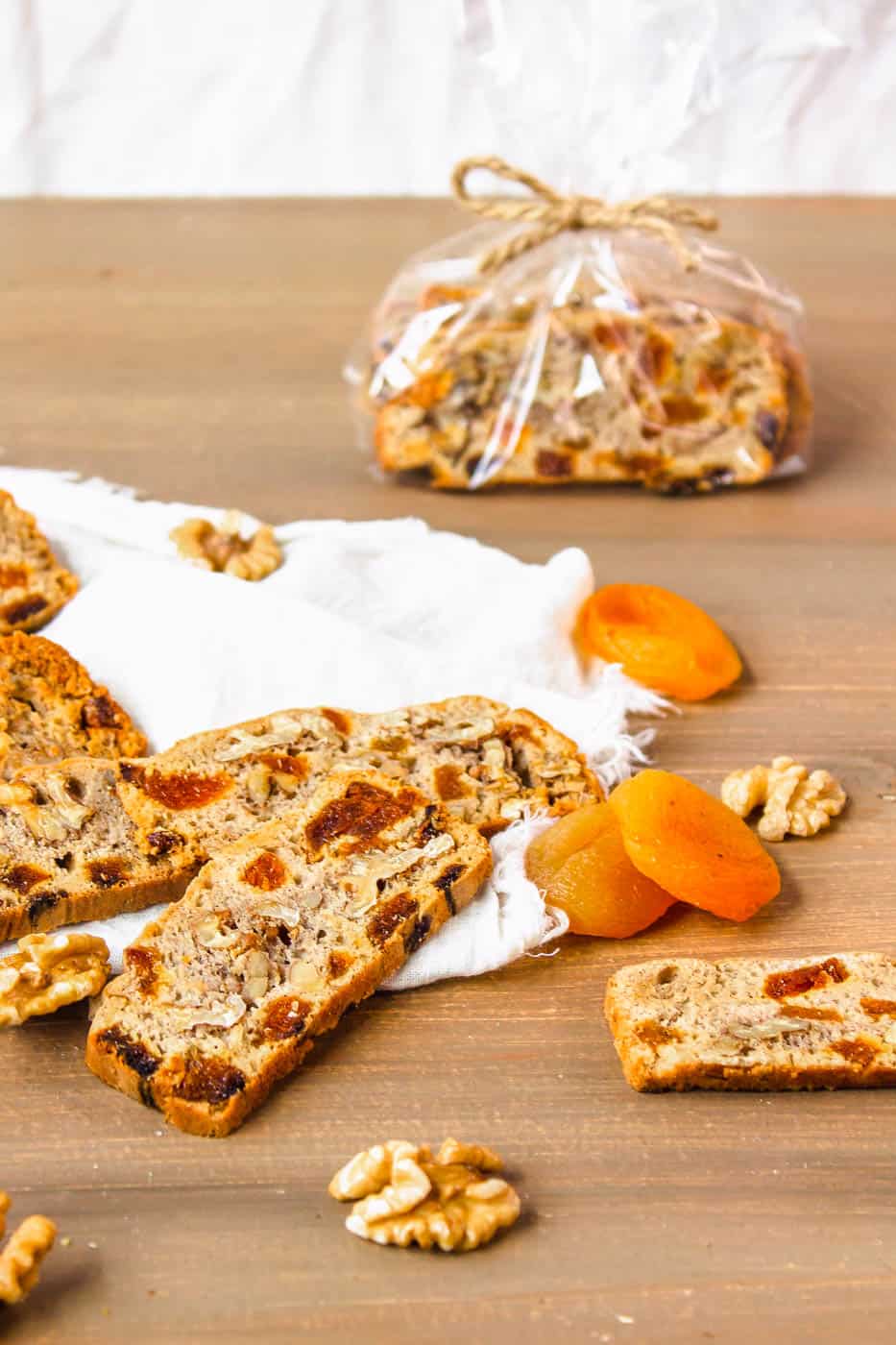 gluten free biscotti with apricots and walnuts on a wooden cutting board