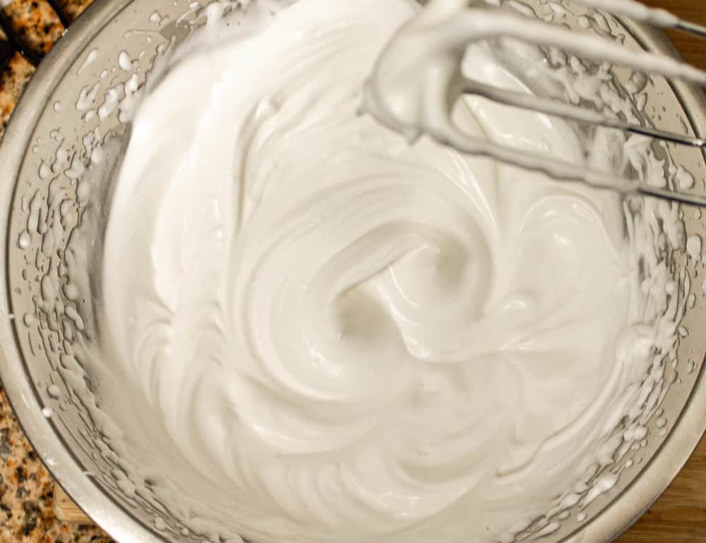 aquafaba whipped in a mixing bowl