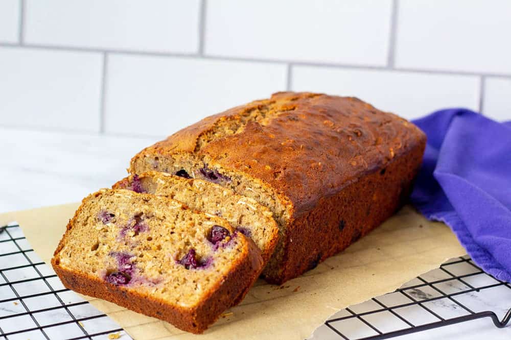 blueberry bread, sliced, on a cooling rack
