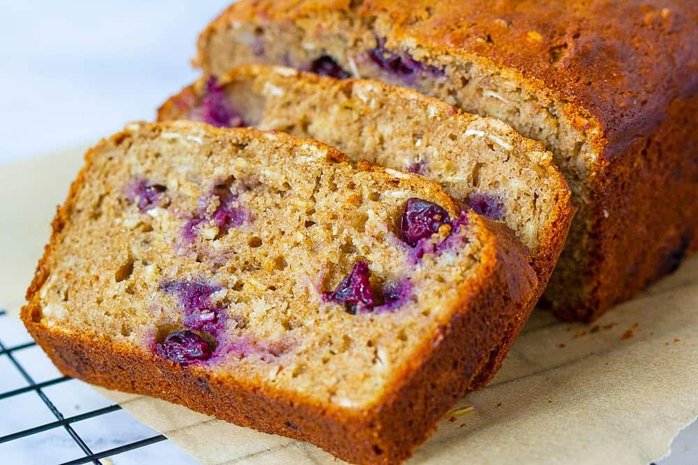 blueberry bread, sliced, on a cooling rack
