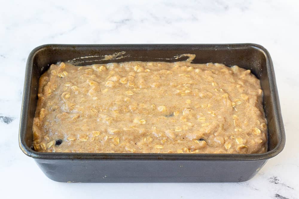 Blueberry banana bread batter poured into a baking pan before baking.