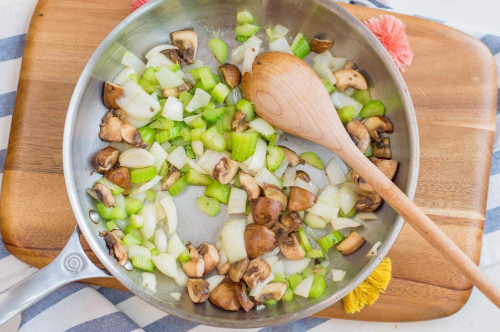 mushrooms celery and onions sauteeing in a pan