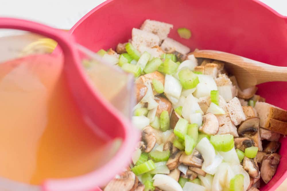 broth being poured into mixing bowl