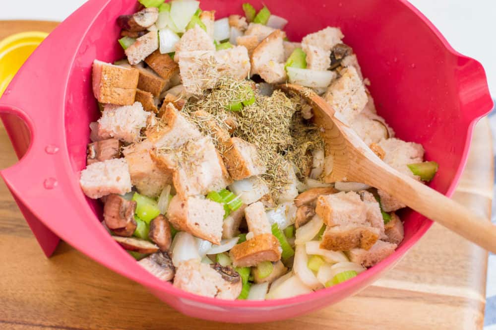 bread and herbs and veggies mixed in a bowl