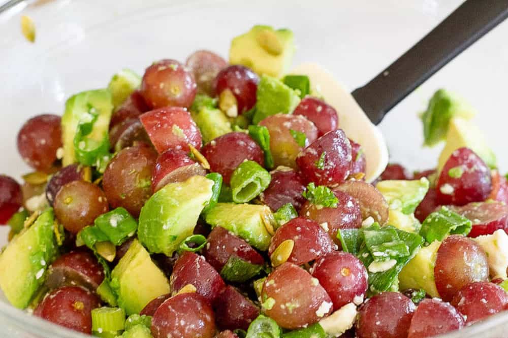 grapes and avocado tossed in a bowl