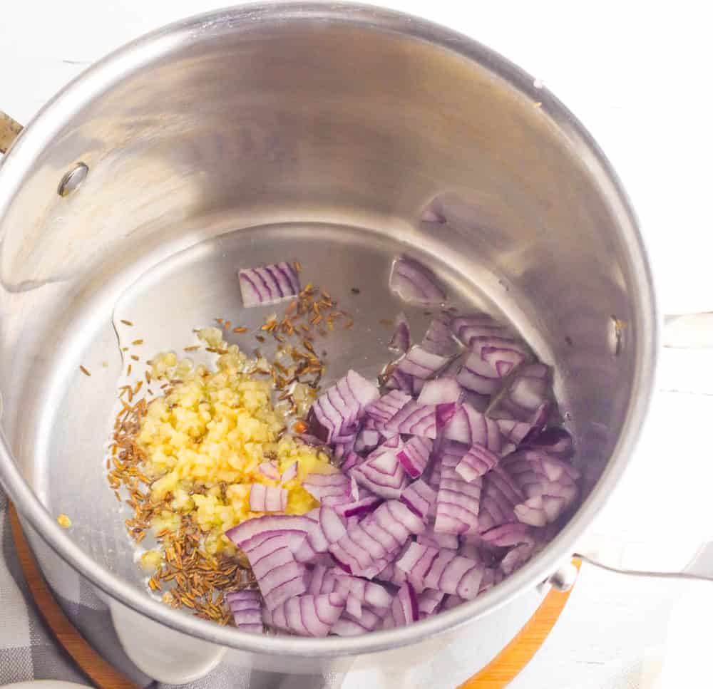 onions and spices sauteeing in a pot
