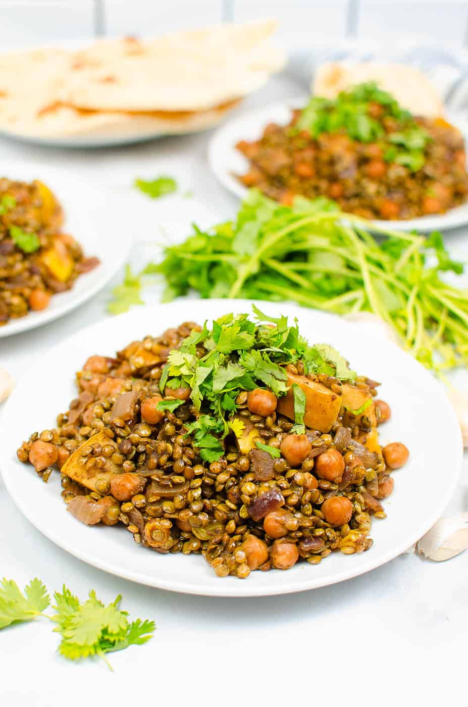 apple curry with lentils and chickpeas served on a white plate
