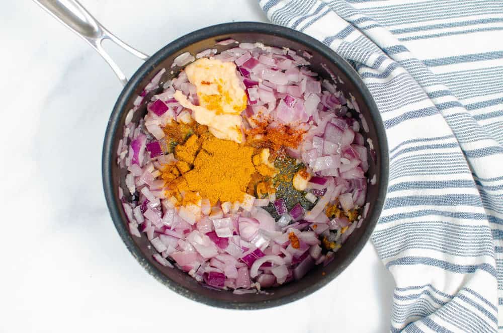 onions and spices sauteeing in a pot