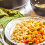 moroccan stew with chickpeas and quinoa couscous served on a white plate