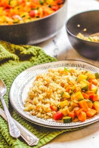 moroccan stew with chickpeas and quinoa couscous served on a white plate