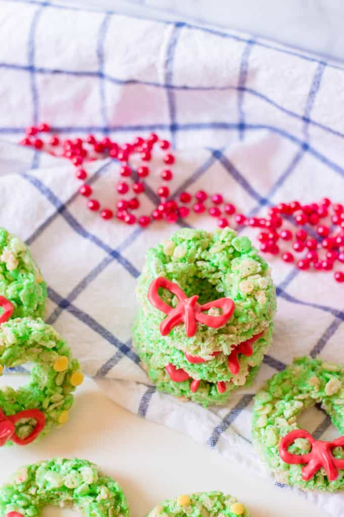 Christmas Rice Krispie Treats with Candy Ribbons against a blue and white background with holiday decorations