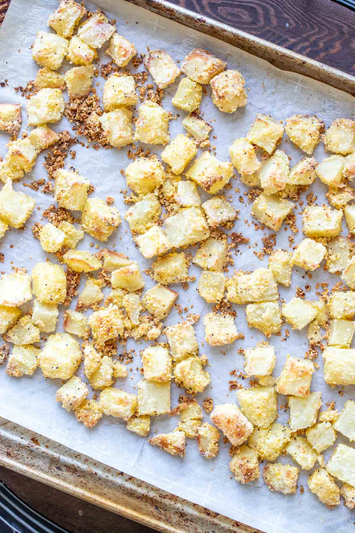 baked crispy potato cubes on baking tray