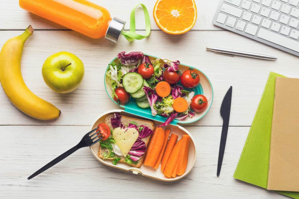 healthy college snacks - snack box pictured next to computer and notebook