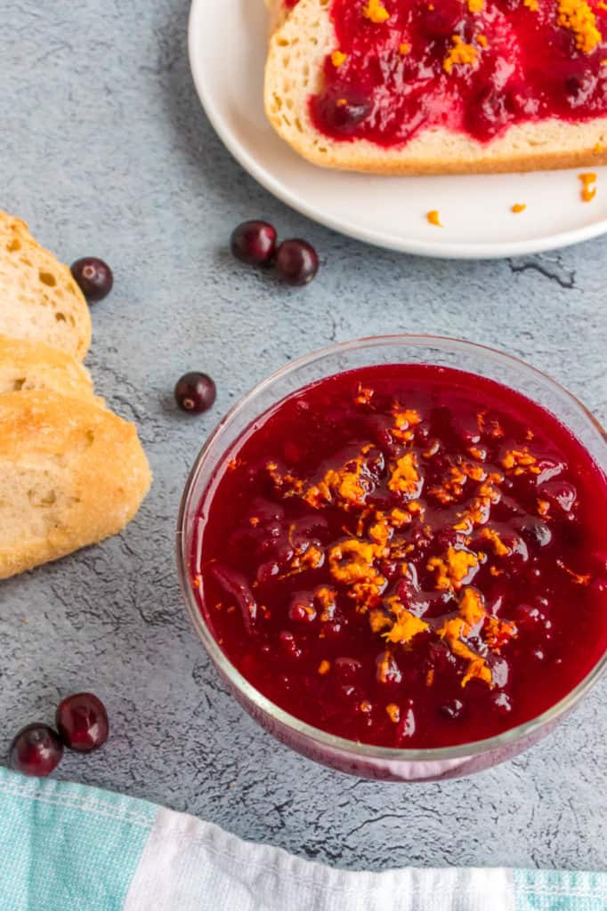 healthy cranberry sauce topped with orange zest served in a glass bowl