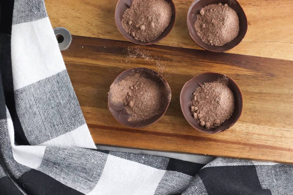 cocoa powder in half shell of chocolate