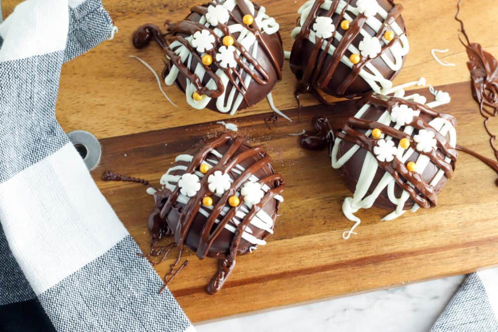 hot chocolate bombs with marshmallows on a cutting board