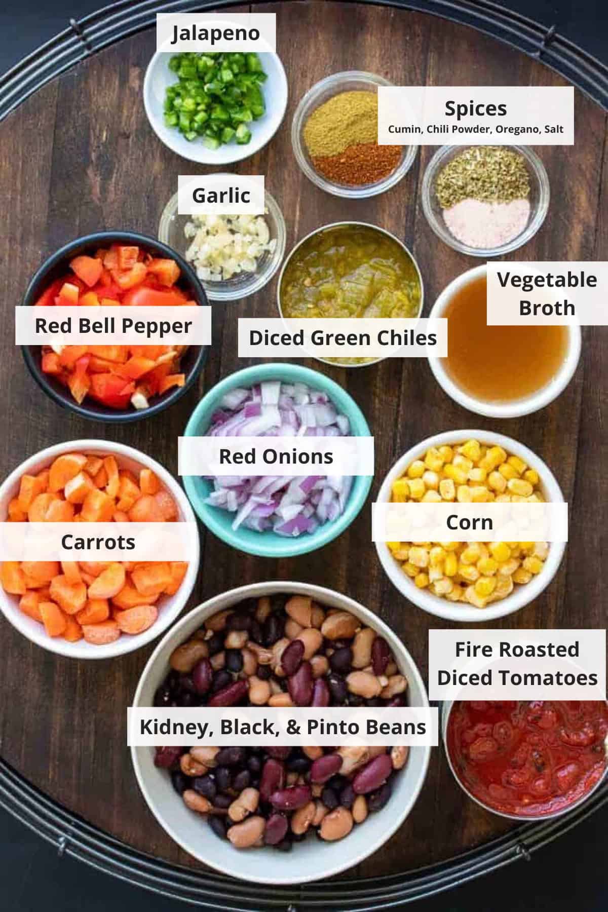 Ingredients for stovetop vegetarian chili recipe on a wood background.