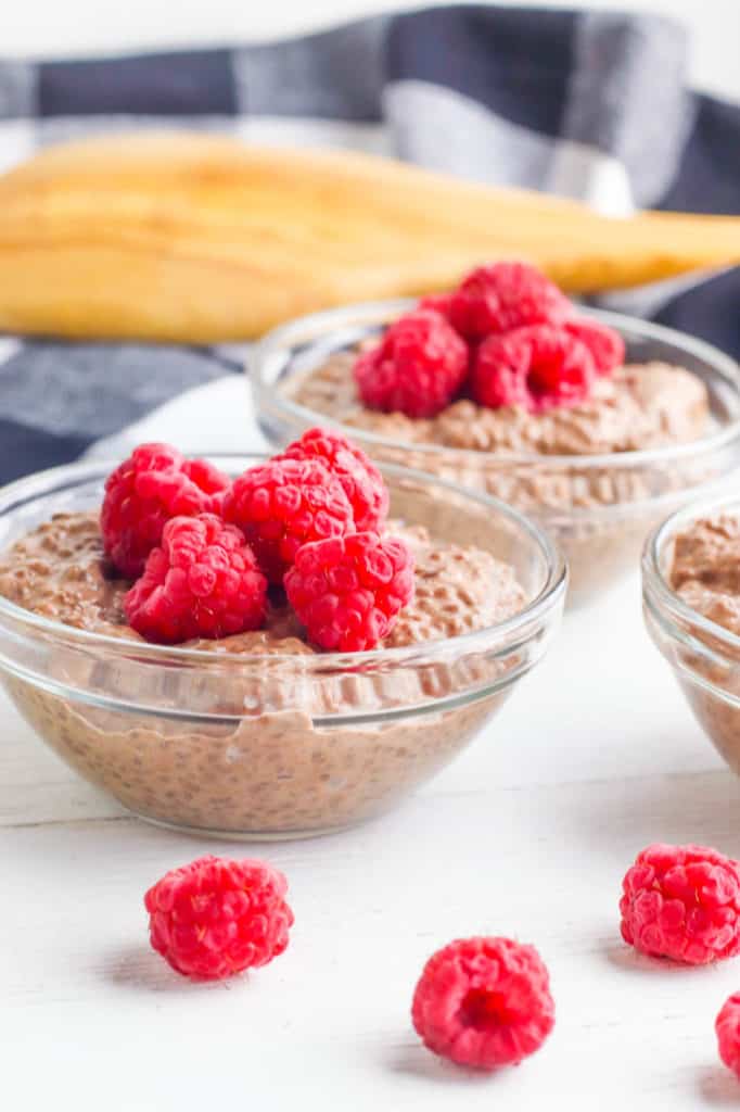 vegan chocolate mousse topped with raspberries served in a glass bowl -romantic desserts for two: 