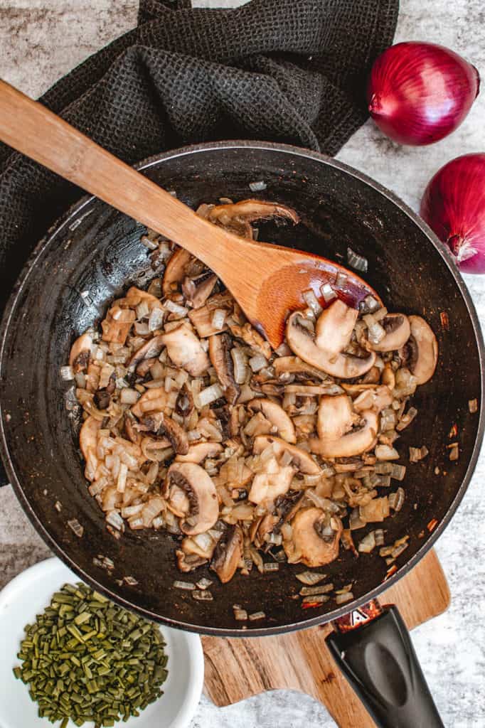 mushrooms and garlic sauteeing in a pan