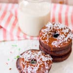chocolate doughnuts with chocolate icing and sprinkles / coconut shreds