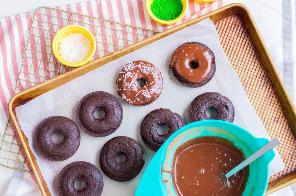 chocolate doughnuts being iced