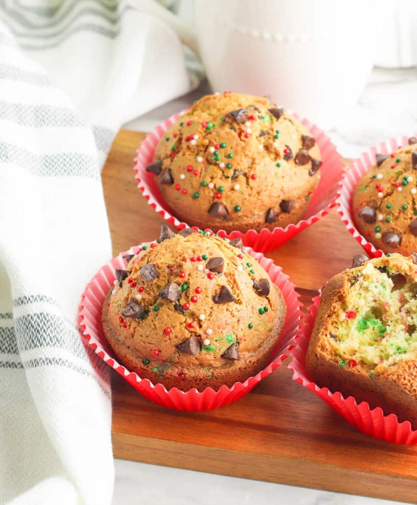 christmas muffins with chocolate chips on a wooden cutting board